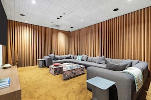 A modern living room with a sectional sofa, a coffee table, and a small side table. - Parkrise 902 | Modern Brunswick 2BR, 2 Bathrooms (Brunswick)