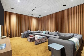 Ein modernes Wohnzimmer mit einer Eckcouch, einem Couchtisch und einem kleinen Beistelltisch.