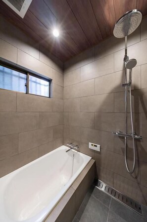 A modern bathroom with a bathtub, a shower, and a window. - JAPAVISTA Leggero (BAIKA, KONOHANA-WARD, OSAKA-CITY)