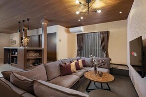 A modern living room with a sofa, a coffee table, and a TV. - JAPAVISTA Leggero (BAIKA, KONOHANA-WARD, OSAKA-CITY)