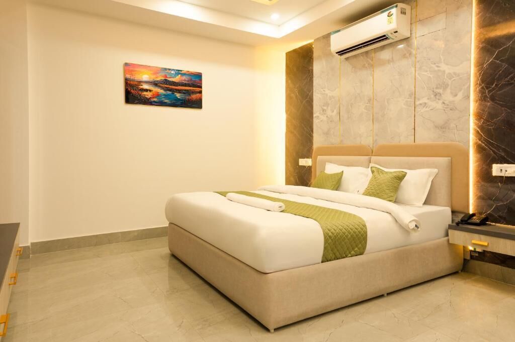 Un dormitorio moderno con una cama grande, un cuadro en la pared y un equipo de aire acondicionado.