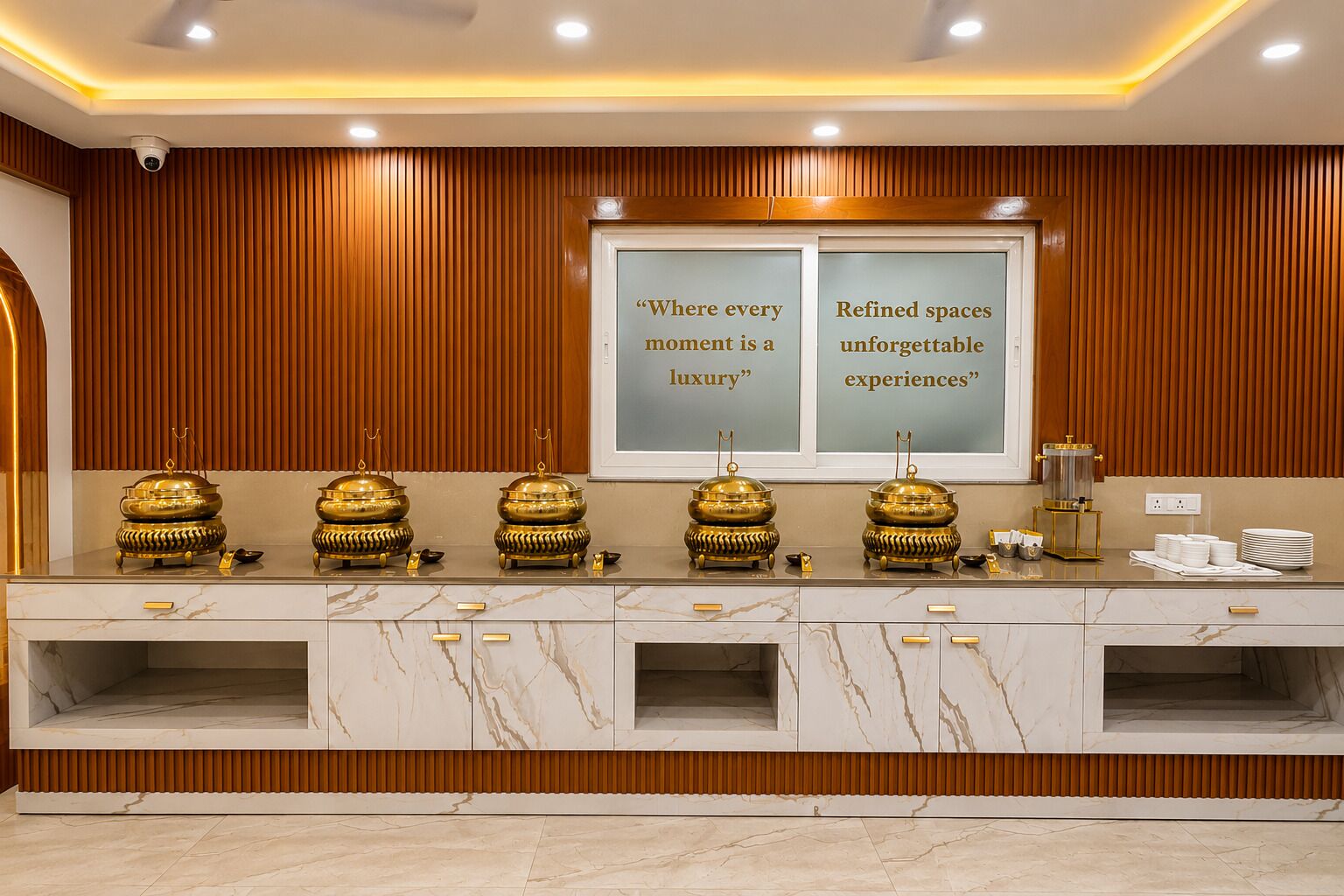 A luxurious hotel reception area with a marble counter, gold-toned decorative items, and a sign stating 'Where every moment is a luxury.'