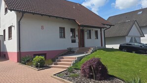 A two-story house with a red-tiled roof, a number '5' on the wall, and a car parked in the driveway. - "Auszeit" Vacation Rental in Irslingen  (Dietingen)