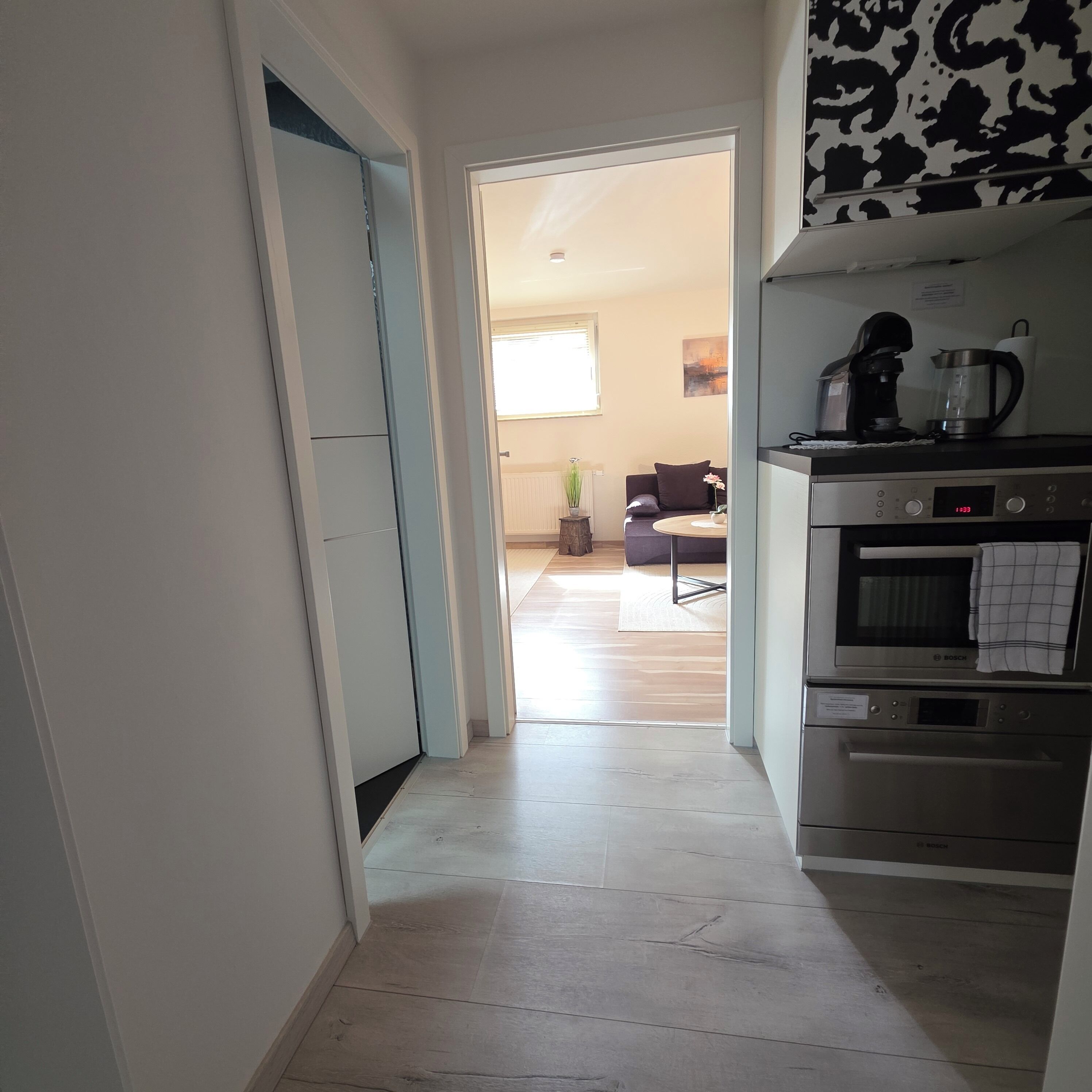 A kitchen with a Bosch oven and a coffee maker.