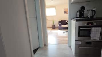 A kitchen with a Bosch oven and a coffee maker.