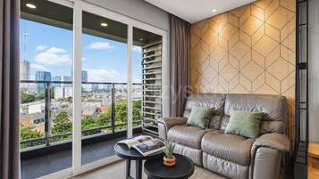 Apartment, 2 Bedrooms, City View | Living area | 50-inch Smart TV with cable channels