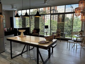 A spacious dining area with a large table, chairs, and pendant lighting. - lEPl Cool 2 Bd Duplex in Poblado W/ Good Location (Medellín)