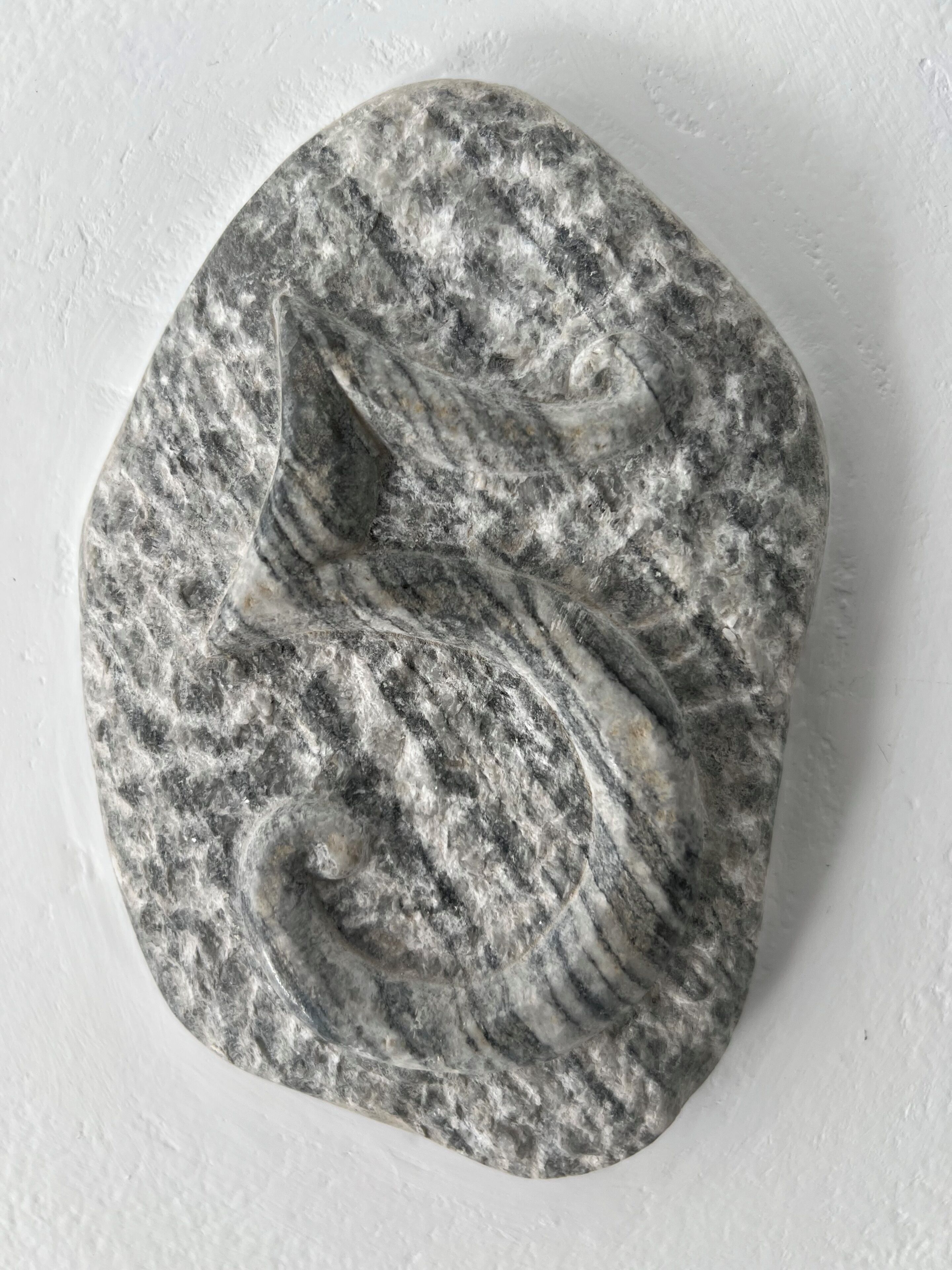 A stone with a carved swan.