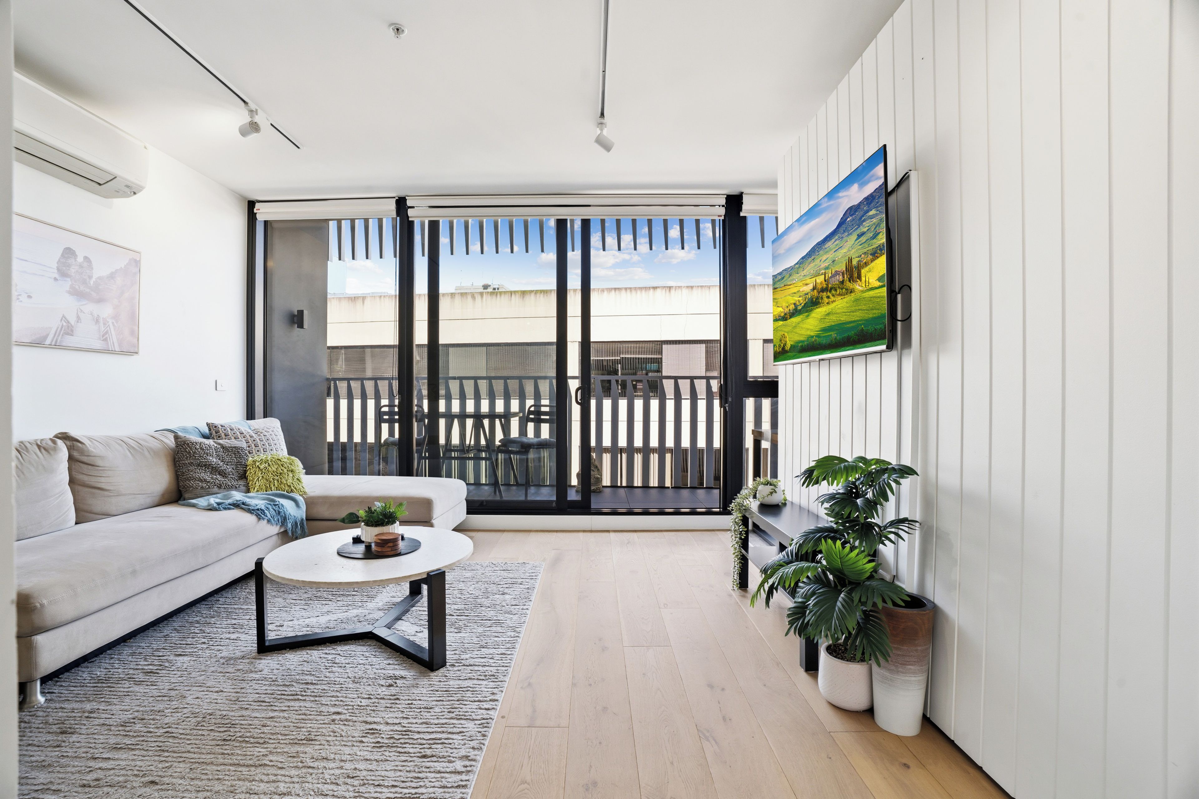 Bright modern lounge with balcony access and abundant natural light