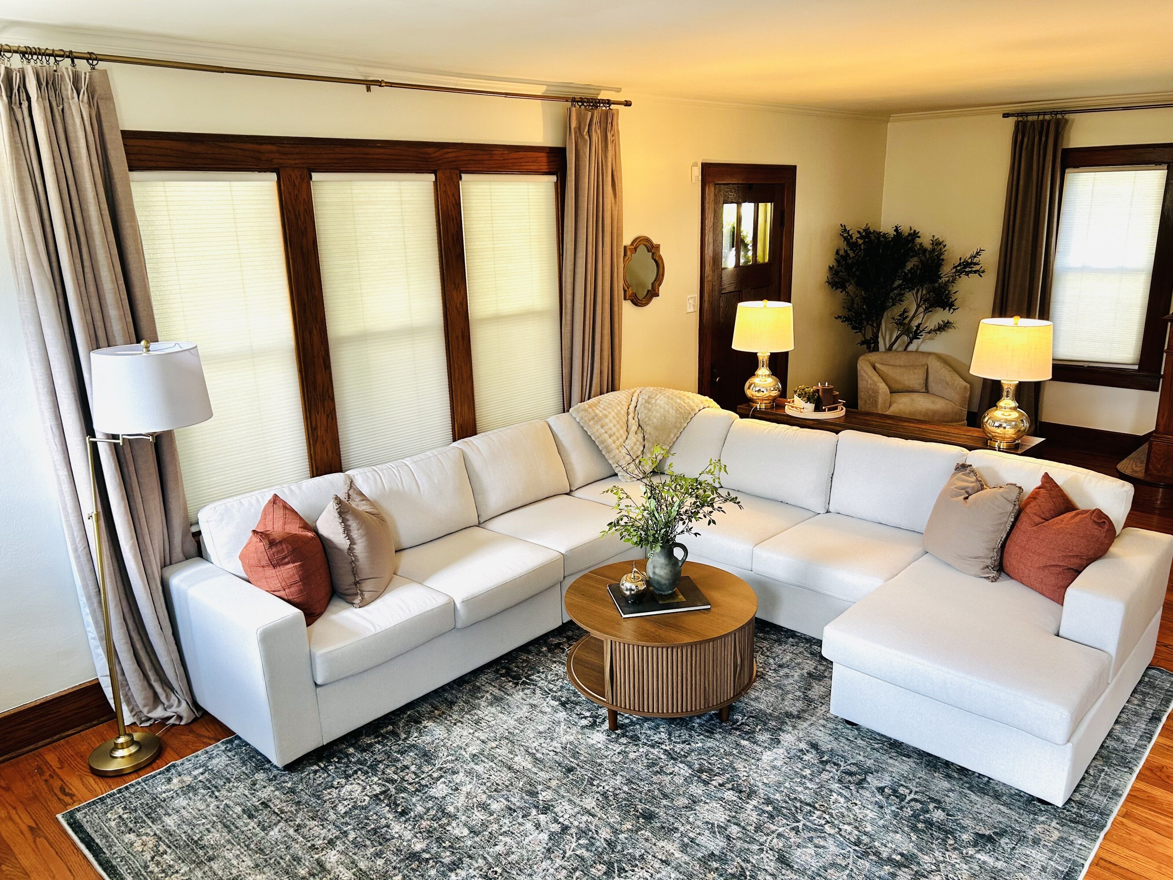 Bright, cozy living room with spacious sectional and warm classic details