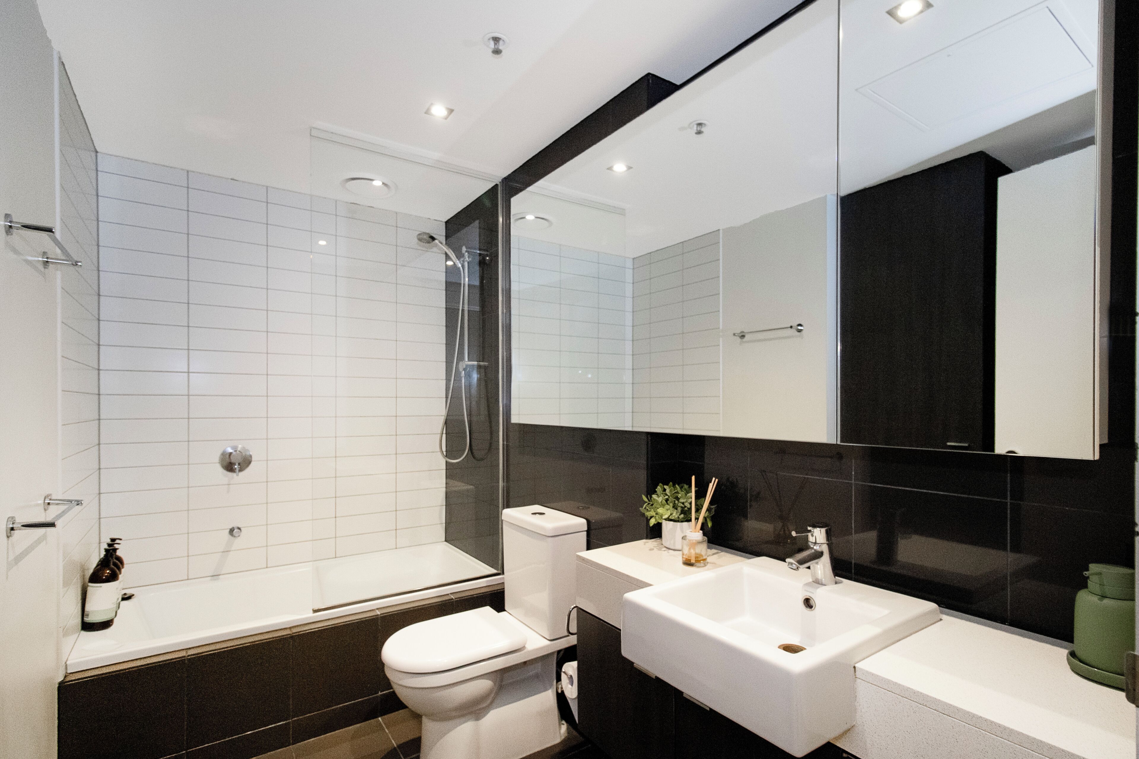 A modern bathroom with a bathtub, toilet, and sink.