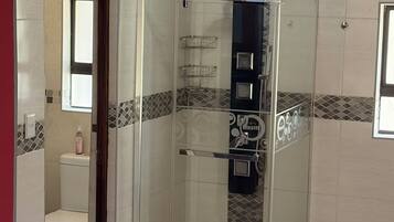 Deluxe Triple Room, Patio, Garden View | Bathroom | Combined shower/tub, hair dryer, towels, soap
