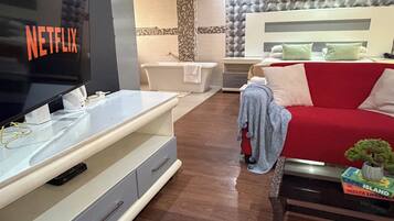 Deluxe Triple Room, Patio, Garden View | Living area