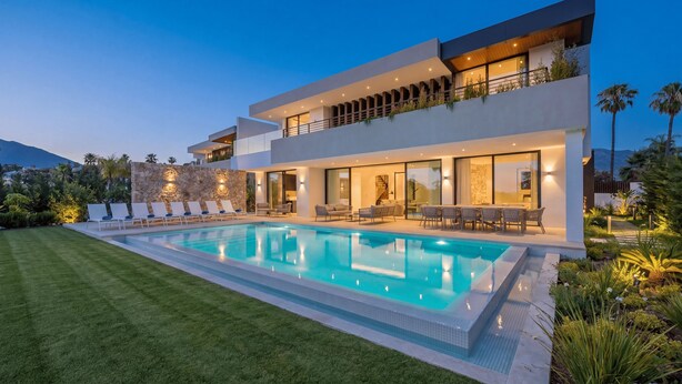 A modern two-story house with a swimming pool, outdoor seating, and a stone wall. - VILLA TROPHY BY VACATION MARBELLA (Marbella)