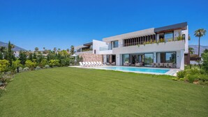 A modern two-story house with a swimming pool, surrounded by a well-maintained lawn and tropical plants. - VILLA TROPHY BY VACATION MARBELLA (Marbella)