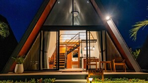 A modern villa with a triangular roof, large glass windows, and a staircase leading to the interior. - Dream Catcher Villas (Singaraja)