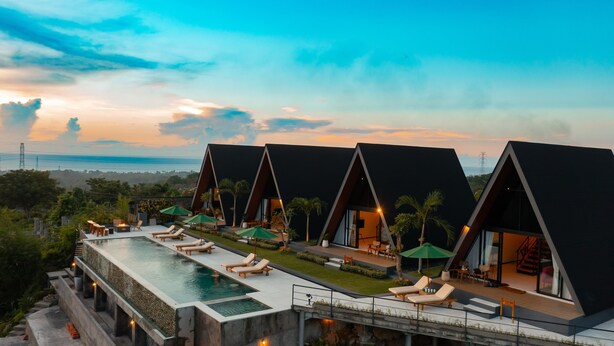 A modern resort with multiple A-frame villas, a swimming pool, and outdoor seating areas. - Dream Catcher Villas (Singaraja)