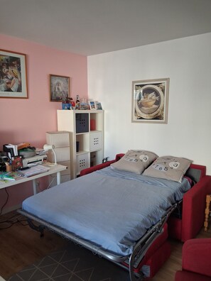 A bedroom with a bed, desk, and shelving unit. - FESTIVAL OF LIGHTS (Lyon)