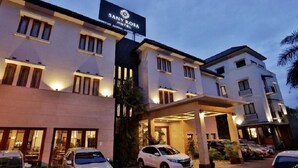 A hotel with a sign reading 'SANY ROYA HOTEL' and multiple cars parked in front. - Sany Rosa Hotel (Bandung)