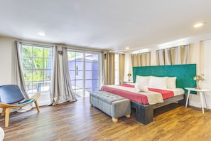 A bedroom with a bed, a chair, a bench, and a small table. - 5 Mi to Soccer Stadium! Zen Retreat in North Miami (North Miami Beach)