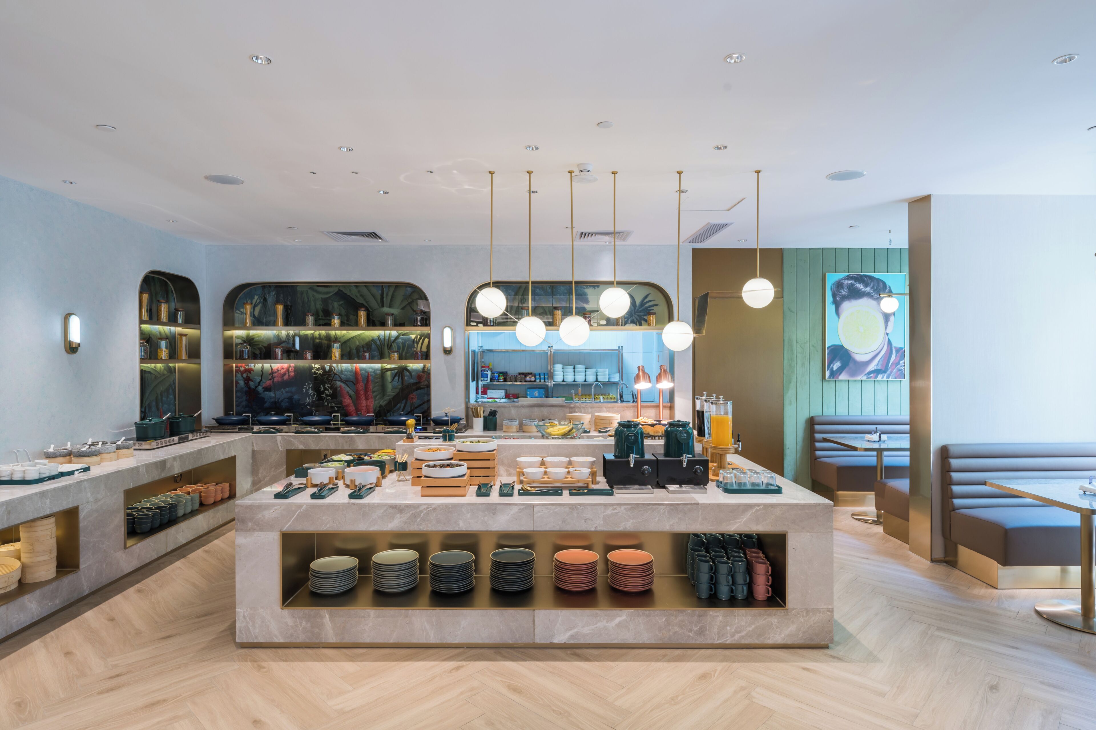 A modern restaurant interior with a central buffet area, seating, and a large painting on the wall.