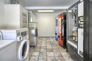 A laundry room with a washing machine, a dryer, and vending machines. - 2 Full Beds with Refrigerator (New Cumberland, PA)