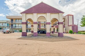 Un bâtiment doté d’un atrium central, de nombreux balcons et d’un parking.