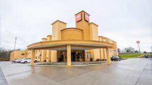 A hotel with a central courtyard, a covered entrance, and a sign indicating it is an OYO hotel.