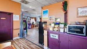 A hotel lobby with a trash bin, a refrigerator, a vending machine, and a sign for 'TRASH.' - King Bed Smoking with Jetted Tub (Columbia)