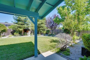 Ein überdachter Patio-Bereich mit Blick auf einen Garten.