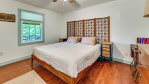 A bedroom with a wooden bed, a ceiling fan, a nightstand, a dresser, and a window with blinds. - Steps to Nolin Lake! Retreat 11 Mi to Mammoth Cave (Cub Run)