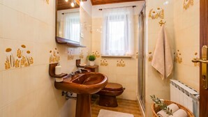 A bathroom with a sink, toilet, and shower. - Marisa Olive Grove Apartments (Labin)