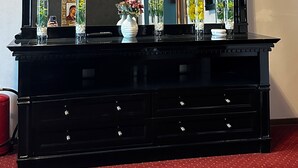 A black dresser with multiple drawers and a large mirror above it. - CROWN ROYAL APARTMENTS (Alba Iulia)