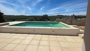 A swimming pool with a view of a rural landscape and a power line in the background. - Quinta do Espinhal, Countryside Retreat Pool (Santarém)