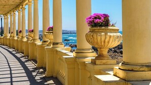 A coastal walkway with columns and flower vases. - Charming 3BR w/ Office Garage by Foz Beaches (Porto)