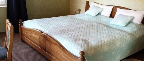 Tabla de planchar con plancha y ropa de cama