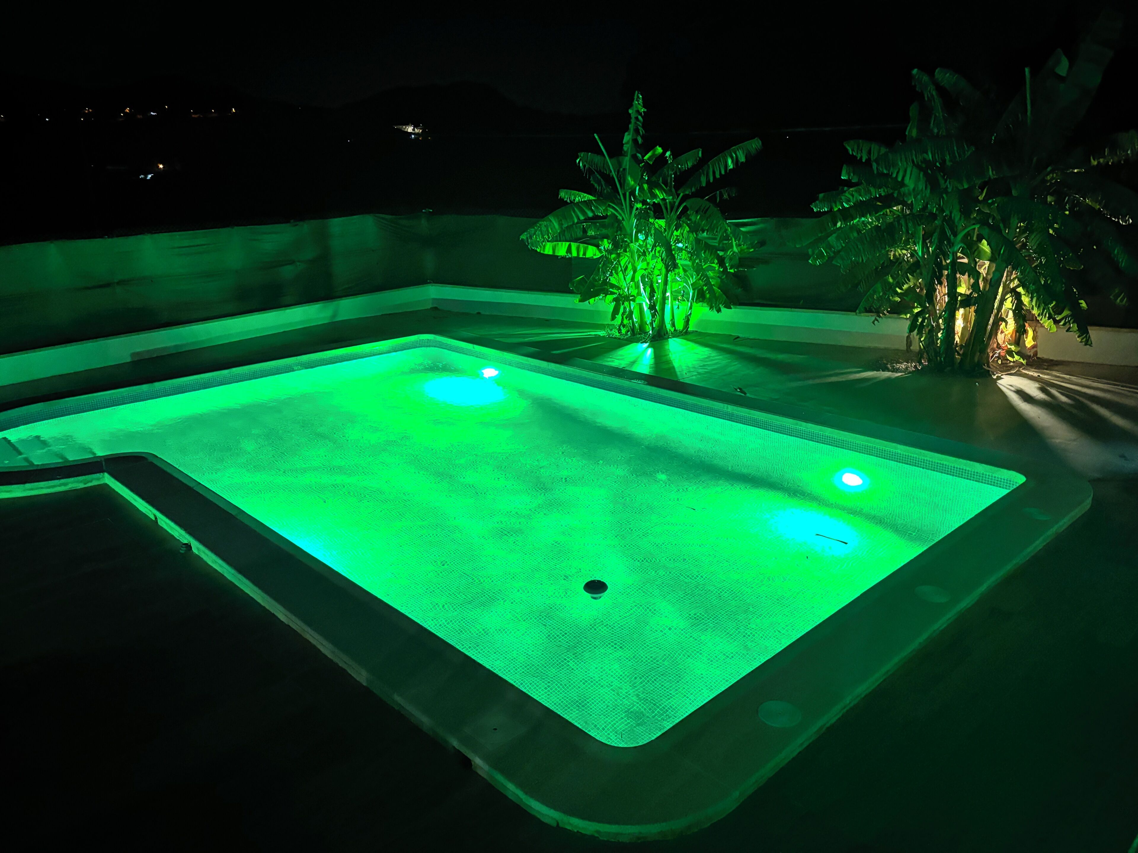 A rectangular swimming pool with a green light.