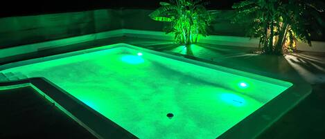 A rectangular swimming pool with a green light.