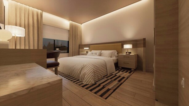 A modern hotel room with a large bed, bedside tables, a desk, and a view of the cityscape. - Fairfield by Marriott Inn & Suites Nags Head (Nags Head)