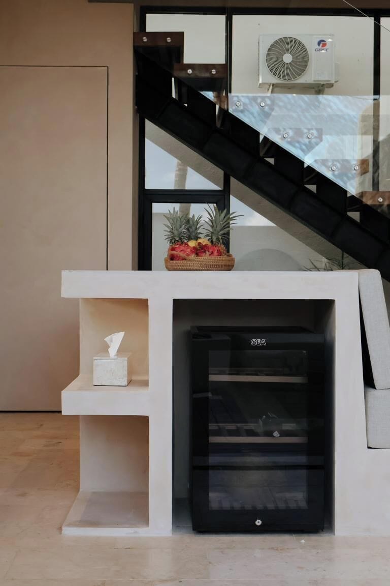 A modern interior with a white console table, a tissue box, and a GE air conditioning unit.