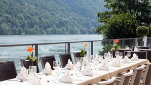A table set for dining with a view of a lake and forested hills. - Hotel Wesenufer (Wesenufer)