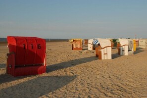 Beach huts numbered 116, 118, and 120, arranged in a row on a sandy beach. - Sea view in the Emma holiday home in Arngast (Varel-Dangast)