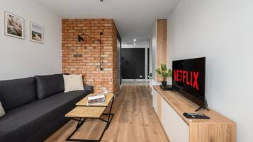 Comfort Apartment, Balcony, City View | Living area | 30-inch Smart TV with satellite channels