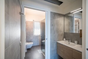 Ein modernes Badezimmer mit Dusche, Toilette und Waschtisch.