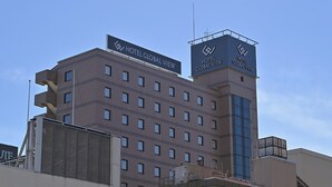 A multi-story hotel with 'HOTEL GLOBAL VIEW' signage, a modern architectural design, and a clear sky.