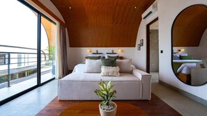 A modern bedroom with a large bed, a potted plant, and a view of the outdoors. - K Club Cemagi Villa 7 (Badung)