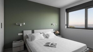 Een moderne slaapkamer met een groot bed, een nachtkastje, een raam met uitzicht en een groene accentmuur.