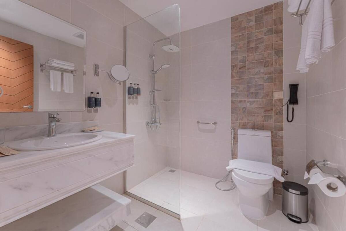 Separate tub and shower, hair dryer, slippers, towels