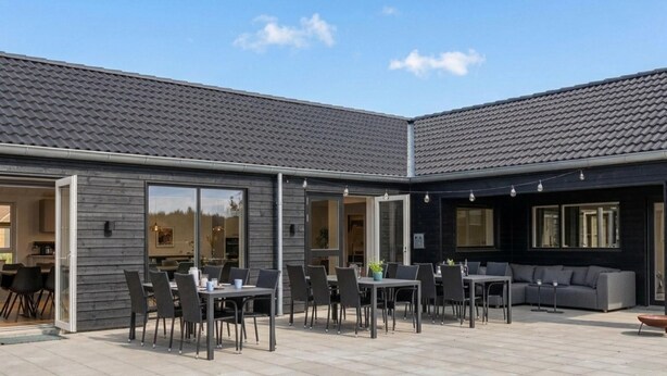 A modern outdoor patio with a dining area, seating, and a sofa. - VillaVilla 961 - Marielyst, Lolland/Falster/møn (Idestrup)