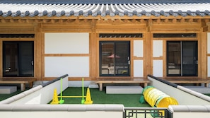 A traditional Japanese building with wooden beams, sliding doors, and a tiled roof.